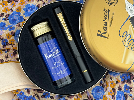Kaweco ink set with pen and ink bottle in a black case on a floral background