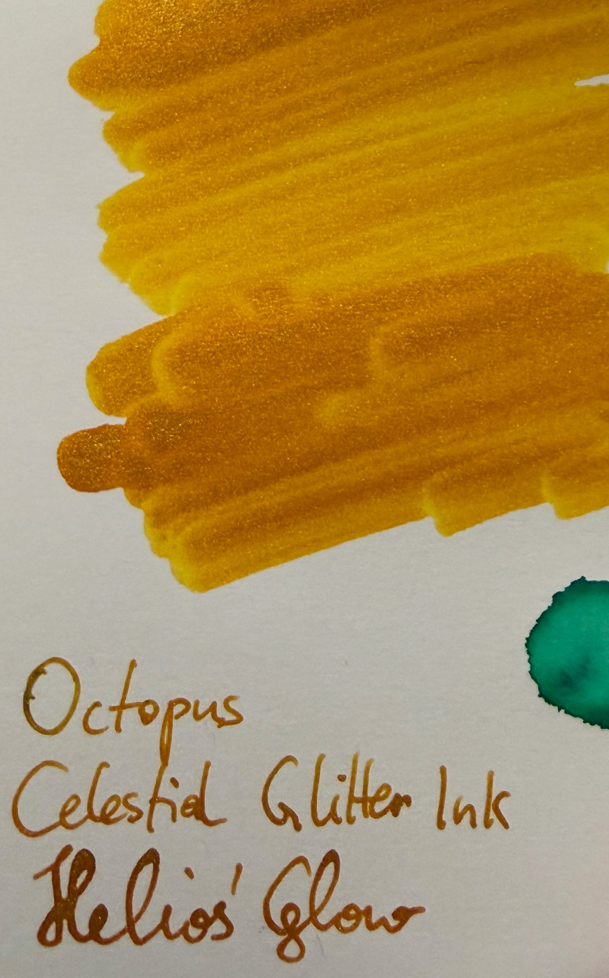 Octopus Celestial Glitter Helios' Glow: ink swatch with a handwritten label.