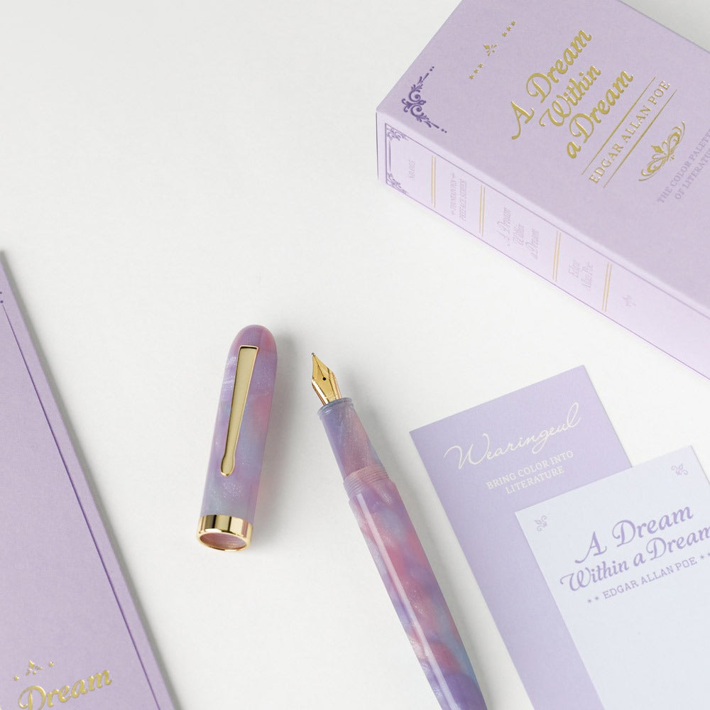 Wearingeul A Dream Within a Dream fountain pen uncapped beside lavender literature cards