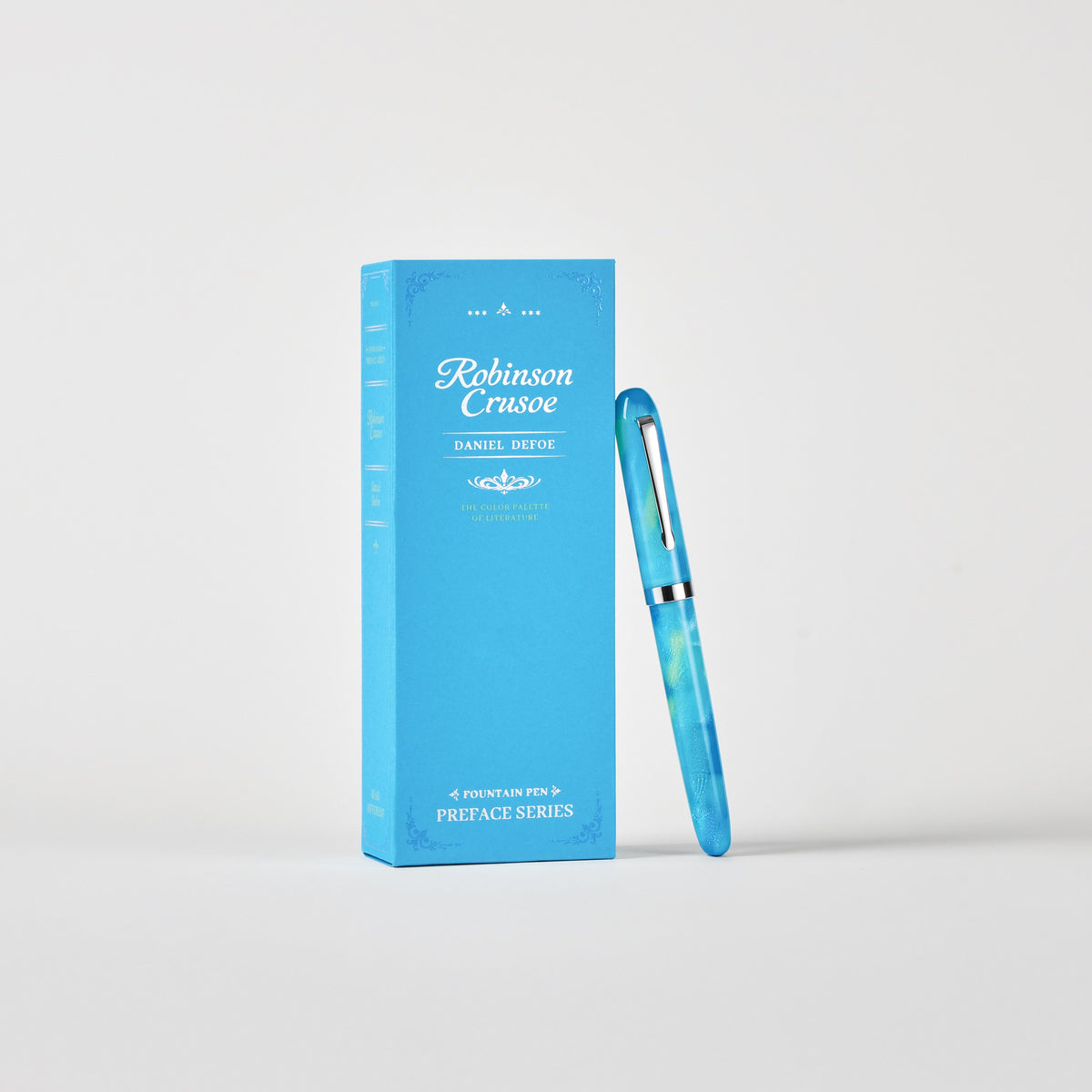 Capped Wearingeul Robinson Crusoe fountain pen with silver-colored trim beside its book-style box